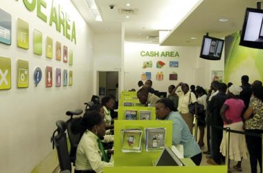 Customers queue for mobile money transfers inside the Safaricom mobile phone care centre in Nairobi