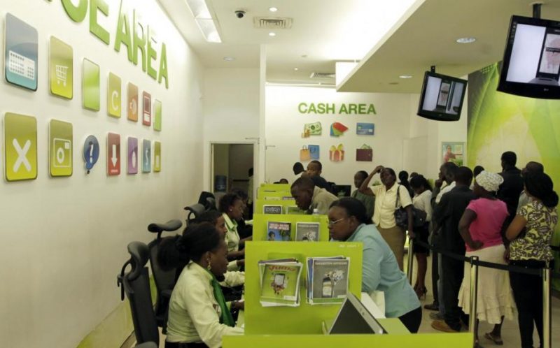 Customers queue for mobile money transfers inside the Safaricom mobile phone care centre in Nairobi