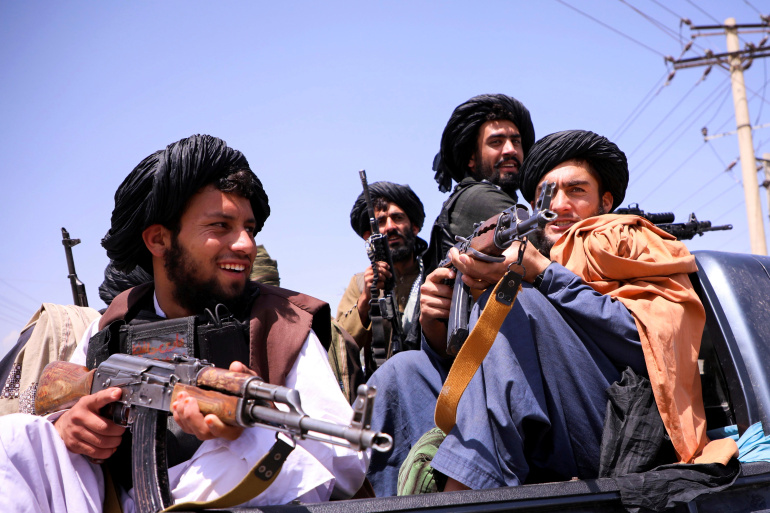 FILE PHOTO: Taliban forces patrol in front of Hamid Karzai International Airport in Kabul