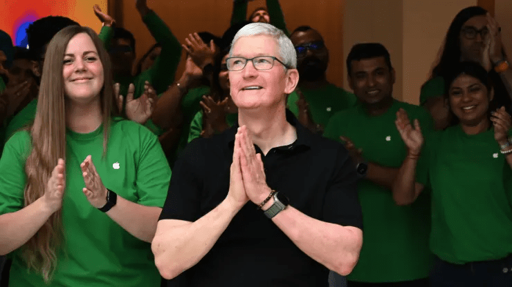 Tim Cook, chief executive officer of Apple Inc., center, greets customers during the opening of the new Apple Saket store in New Delhi, India, on Thursday, April 20, 2023.