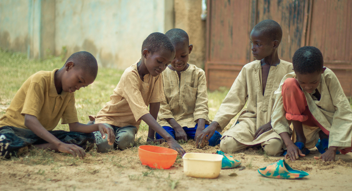 Child baggers seated on the floor